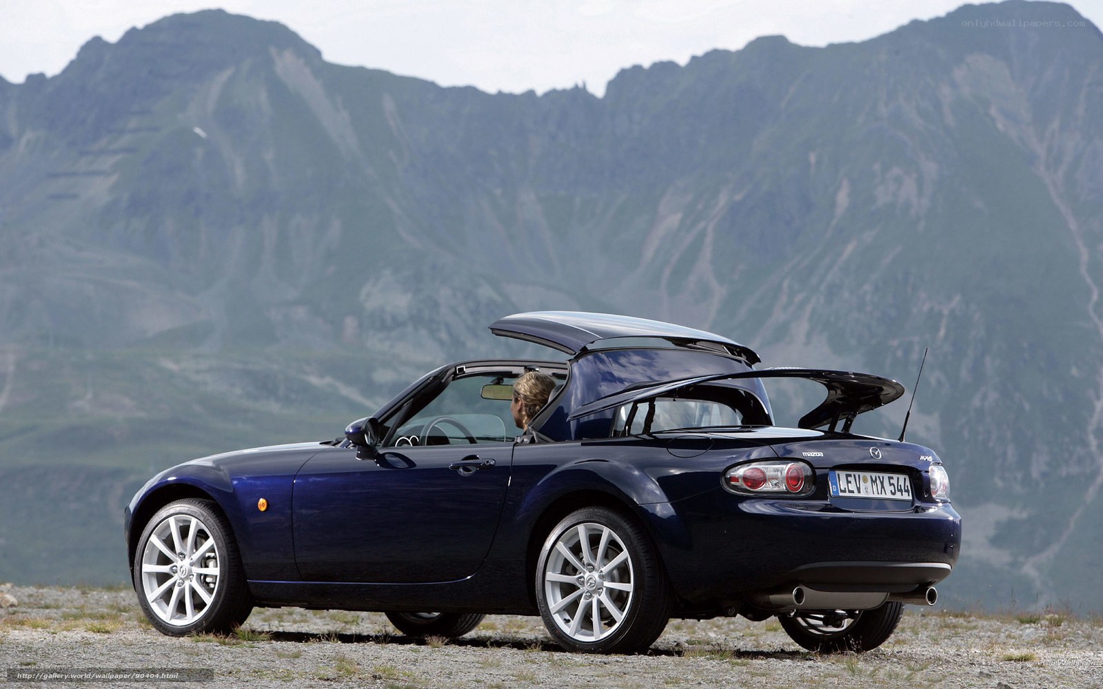 Blue Mazda MX-5 in mountain landscape
