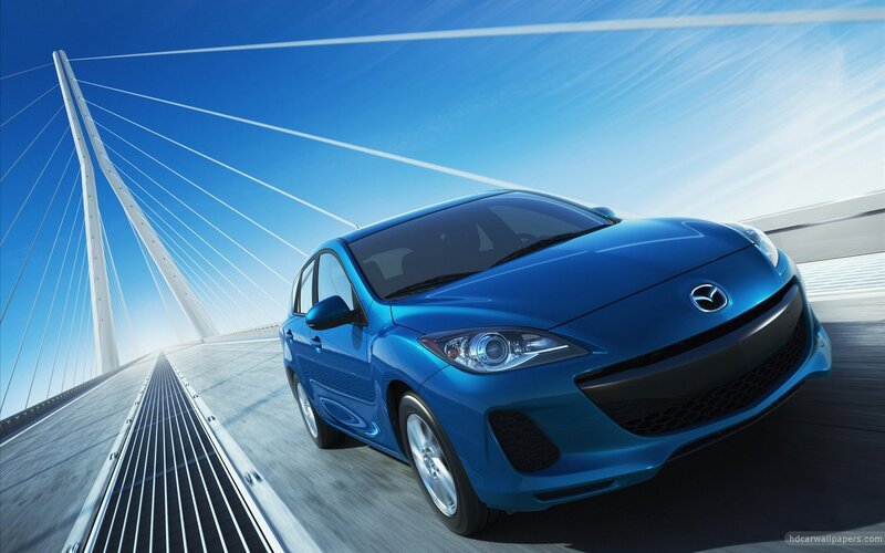 Blue Mazda on a cable-stayed bridge