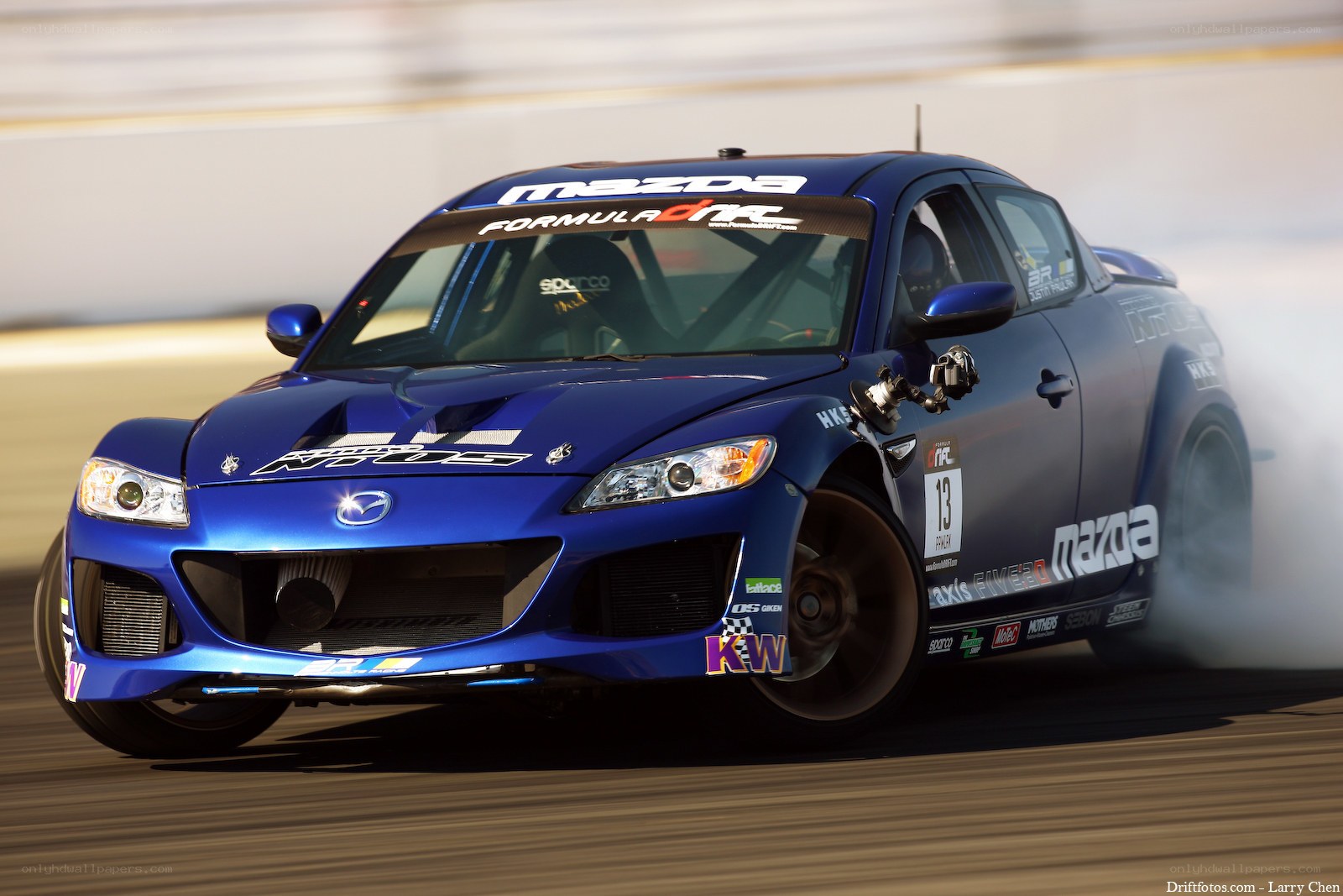 Blue Mazda race car drifting