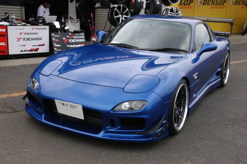 Blue Mazda RX-7 at a motorsport event