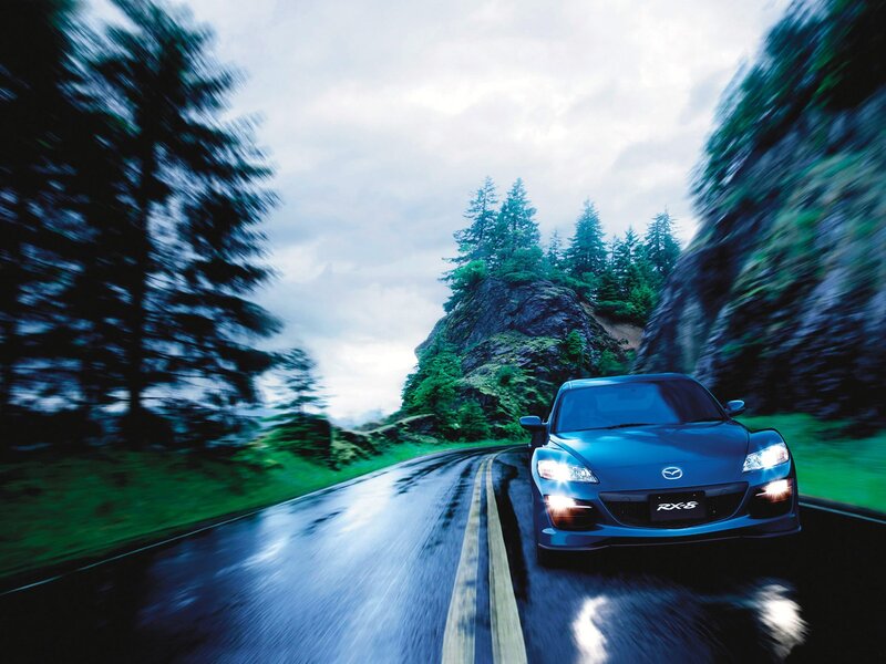 Blue Mazda RX-8 on a wet road