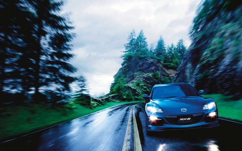 Blue Mazda RX-8 on a wet road