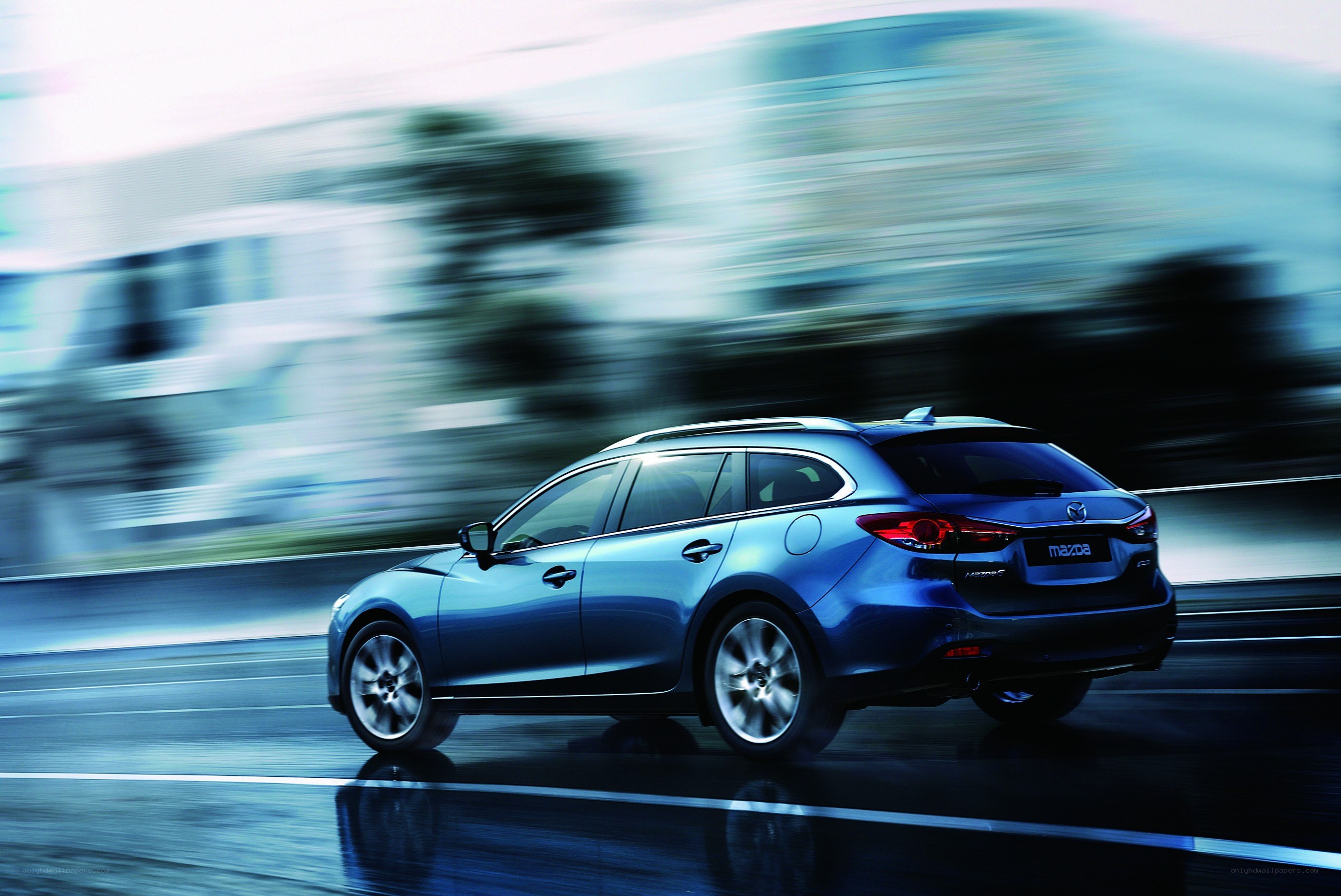 Blue Mazda station wagon in motion