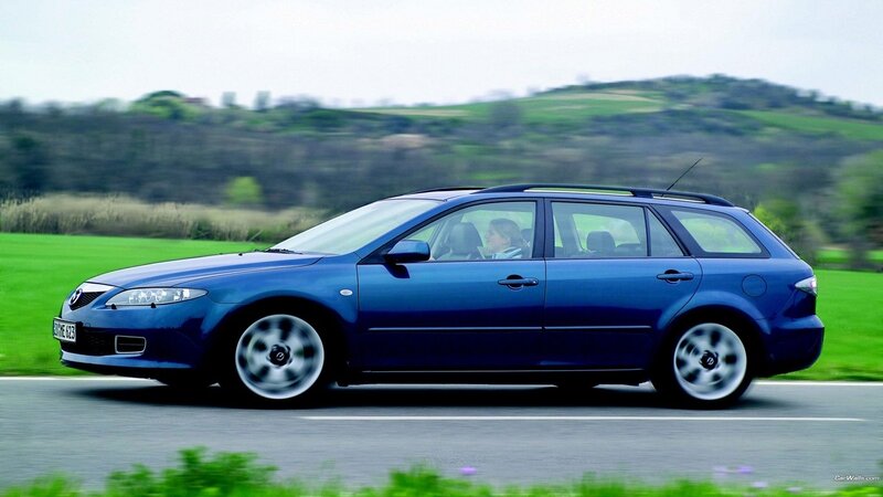 blue mazda station wagon on road