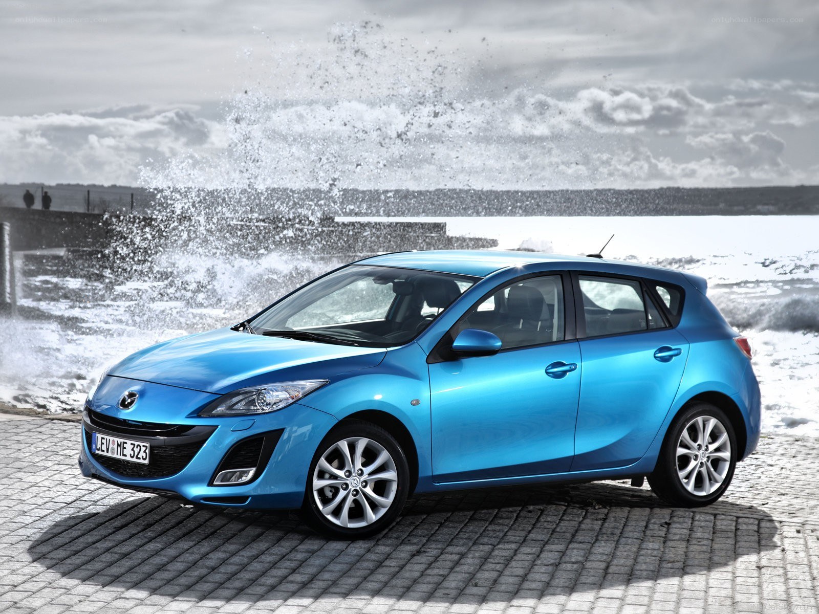 Blue Mazda3 by the sea