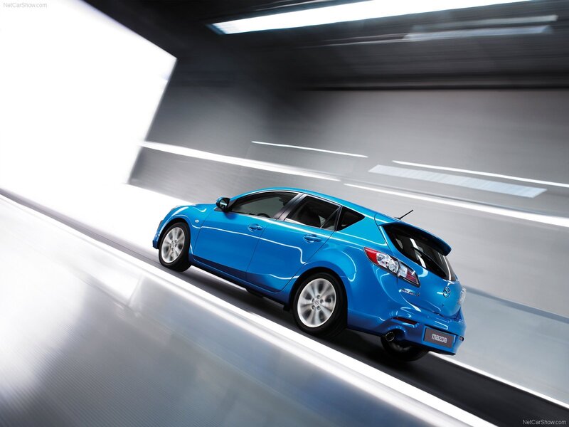 blue mazda3 hatchback in motion