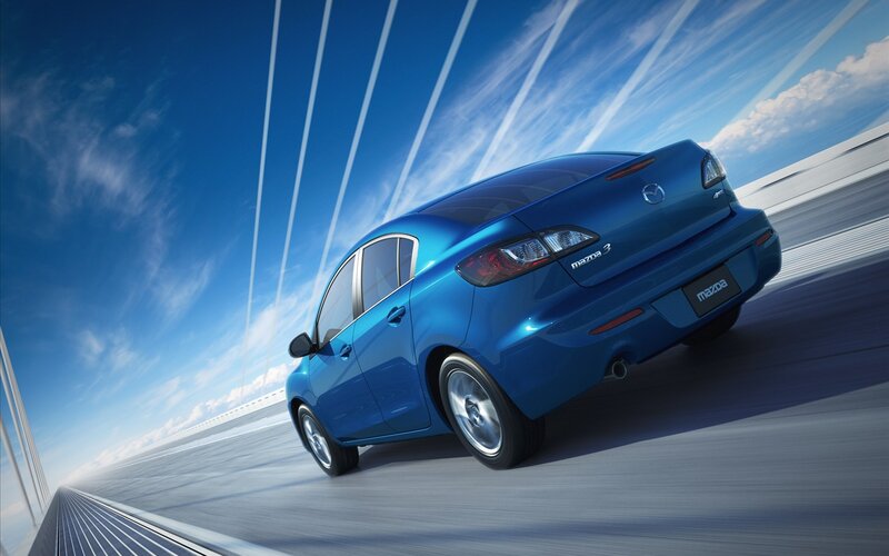 Blue Mazda3 in motion