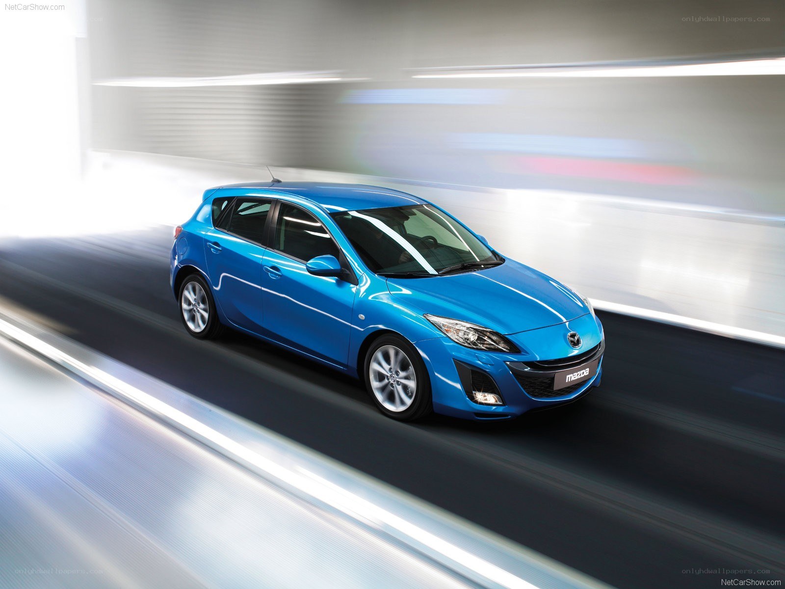 Blue Mazda3 in motion