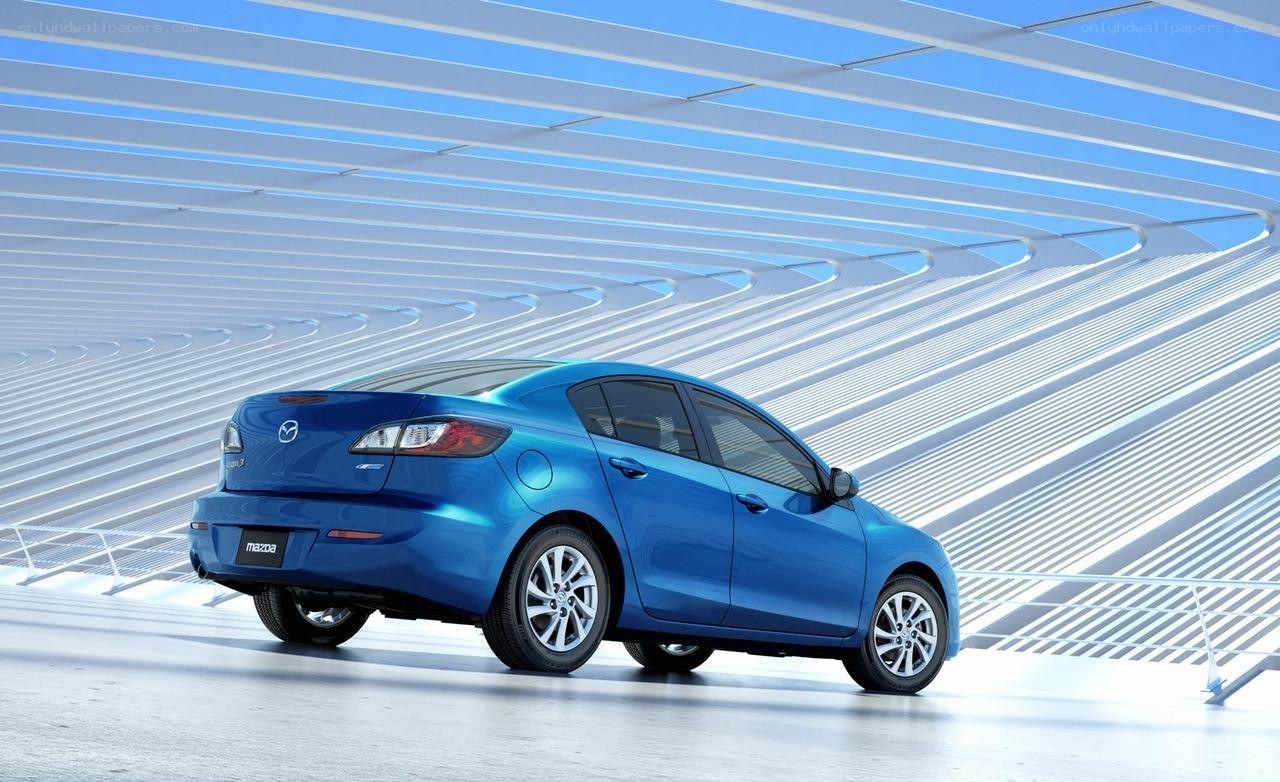 Blue Mazda3 sedan in modern setting