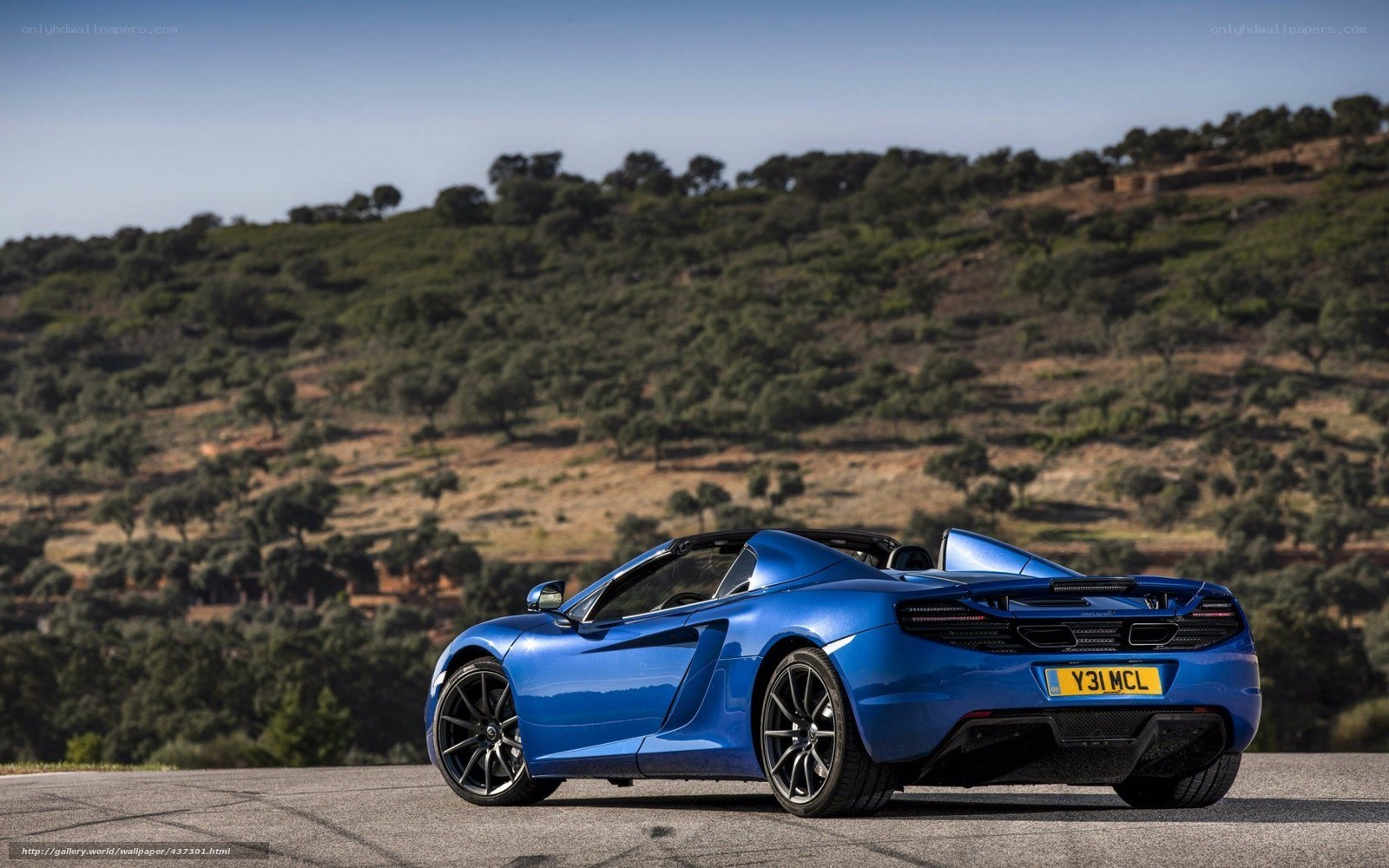 Blue McLaren convertible on a road