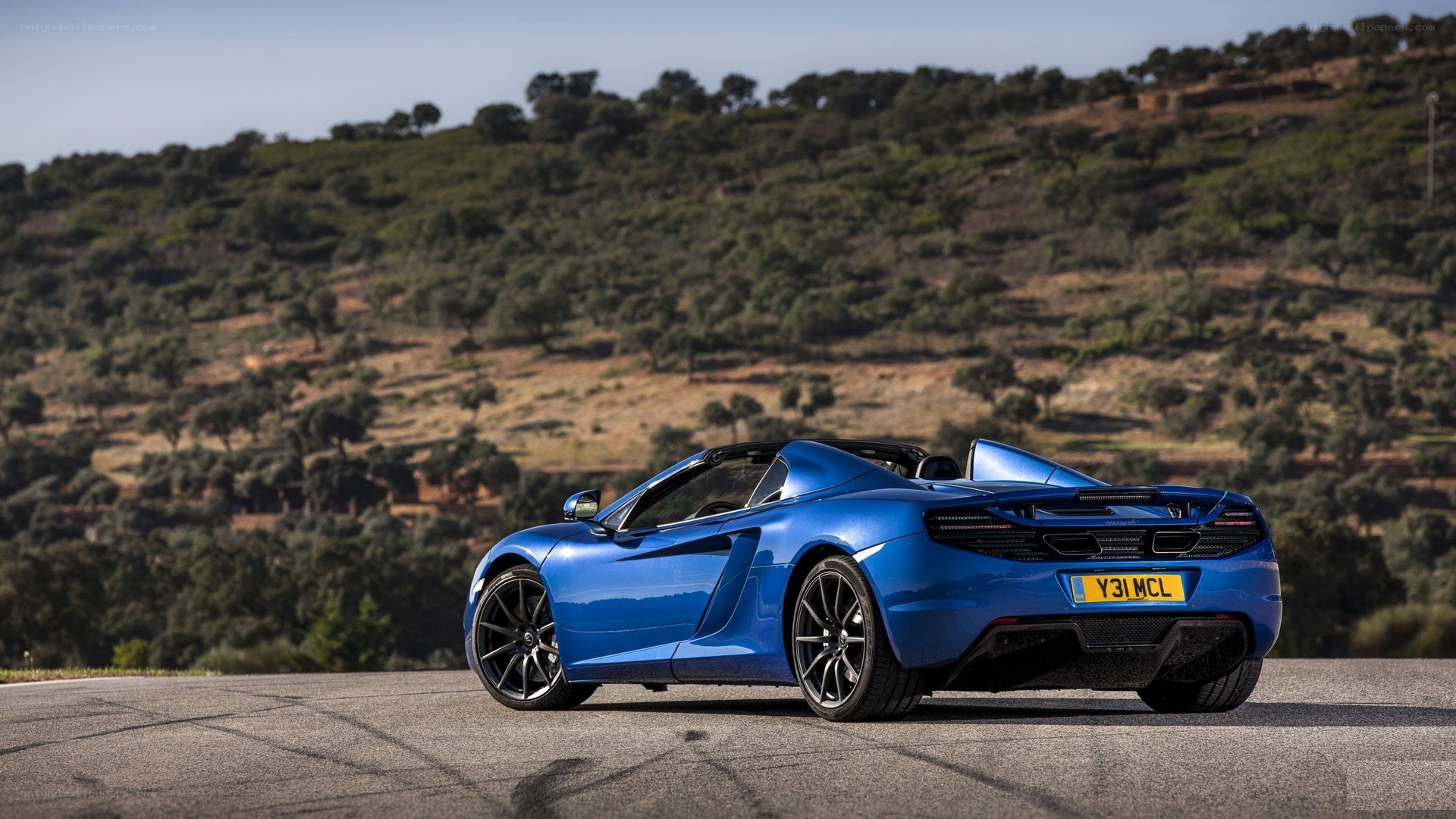 Blue McLaren convertible on road