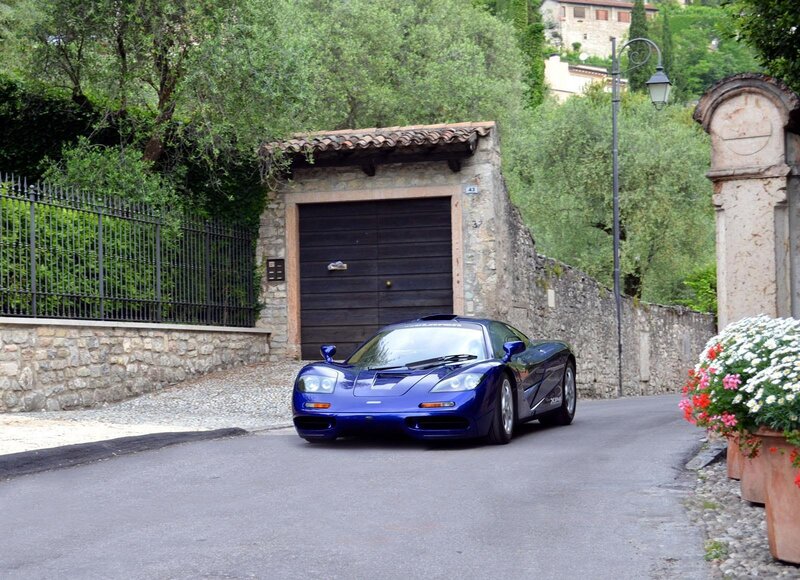 Blue McLaren F1 on a village street