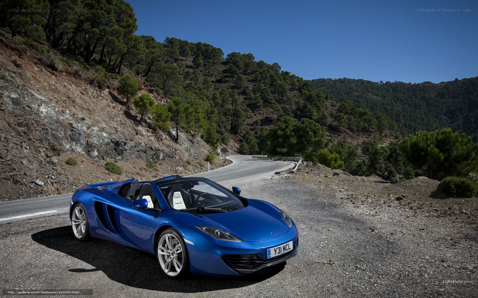 Blue McLaren on a mountain road