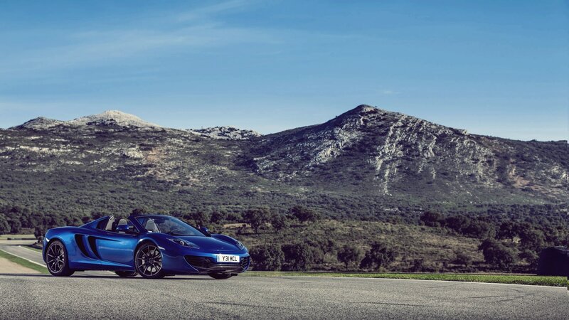 Blue McLaren on a mountain road