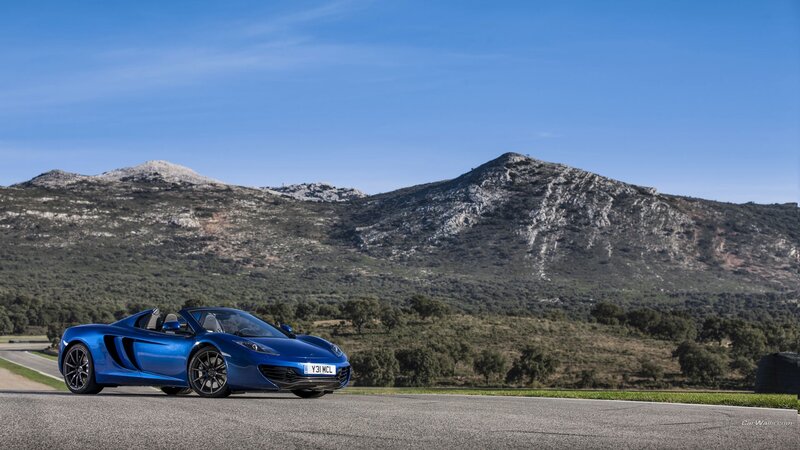 Blue McLaren on a mountain road