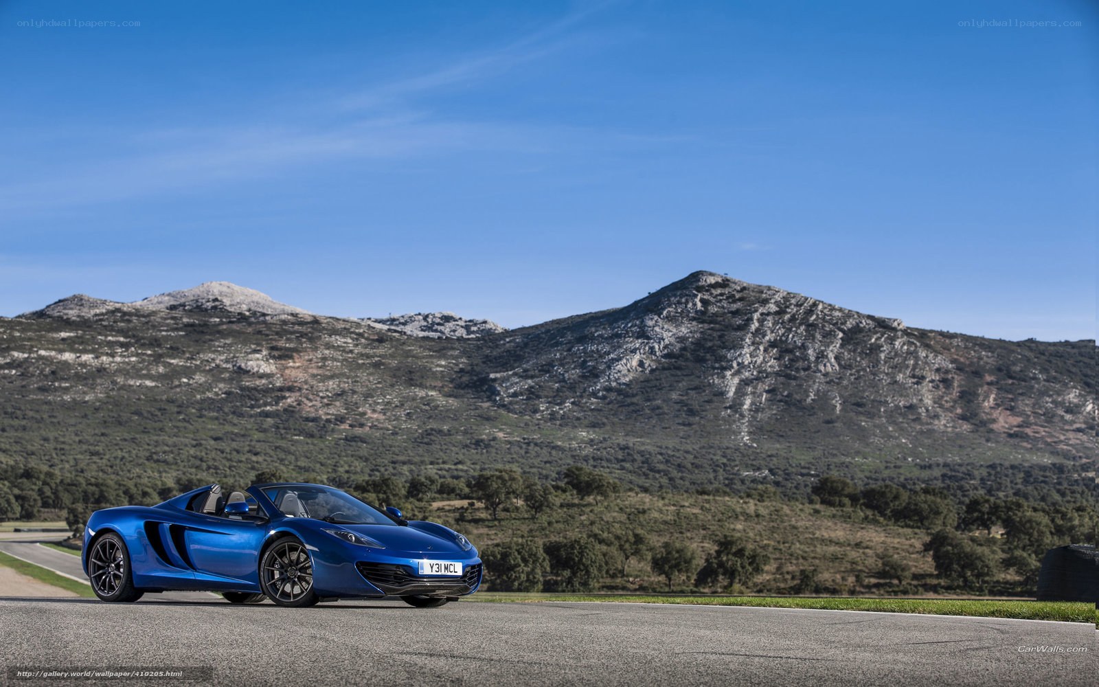 Blue McLaren on a mountain road