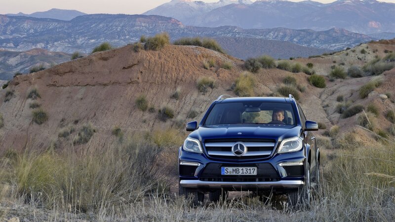 Blue Mercedes-Benz in desert landscape