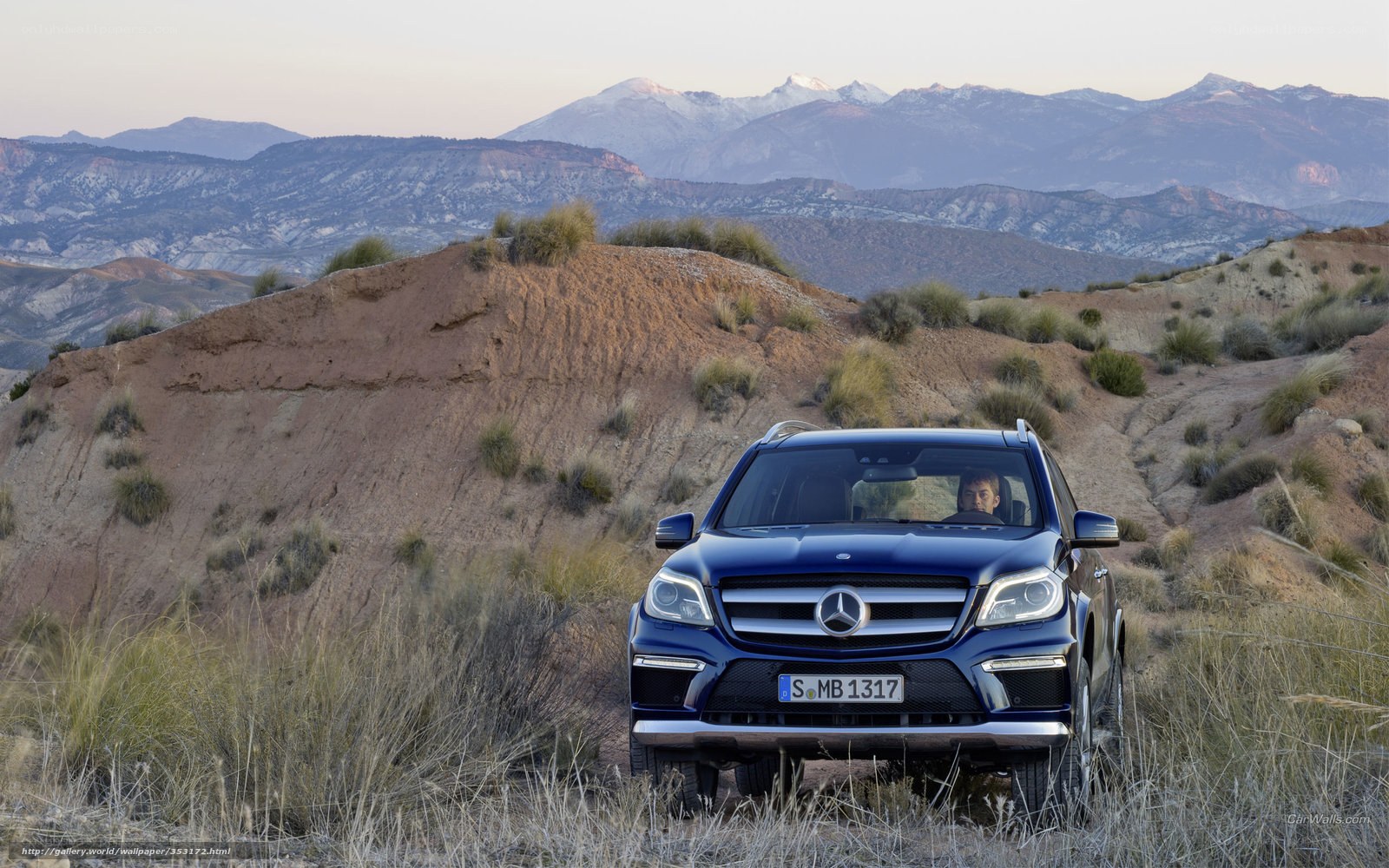 Blue Mercedes-Benz in desert landscape