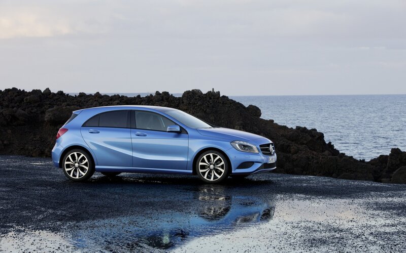 Blue Mercedes-Benz on a rocky shore