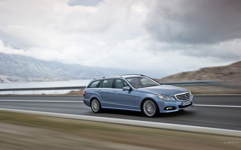 blue mercedes-benz on a scenic road
