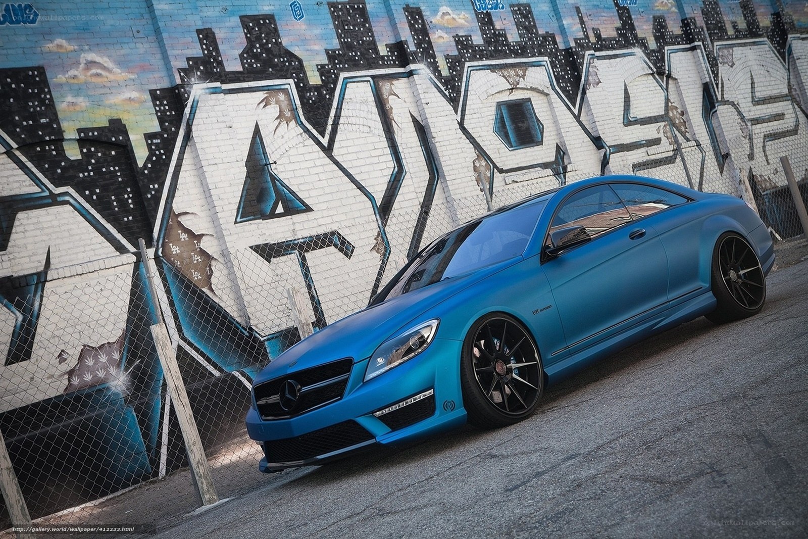 Blue Mercedes-Benz on graffiti wall