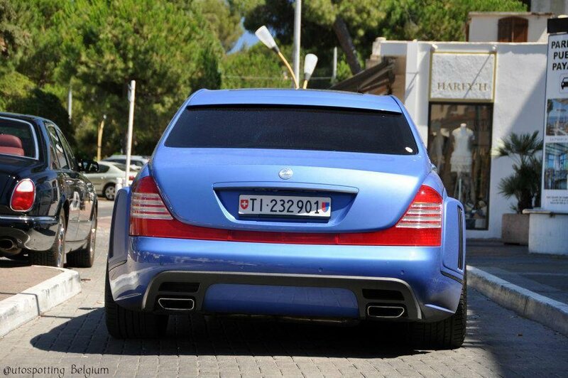 blue mercedes-benz parked on street
