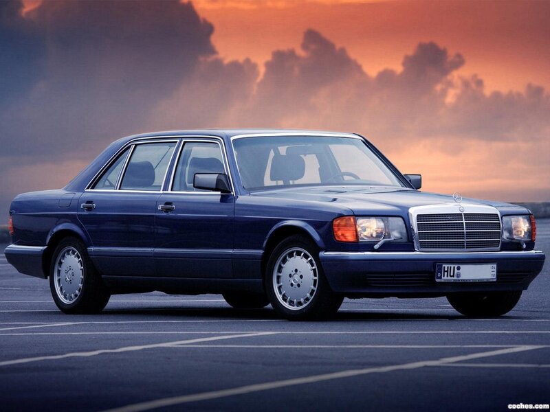 Blue Mercedes-Benz sedan at sunset