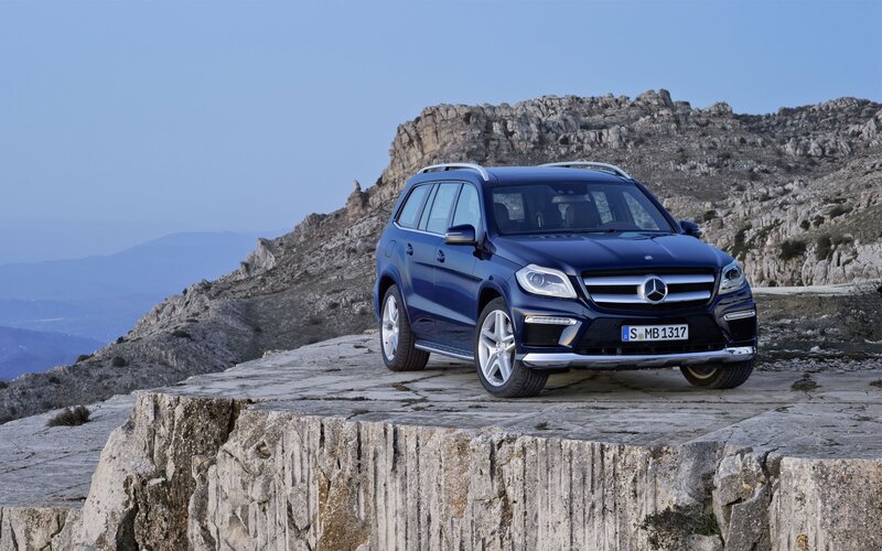 Blue Mercedes-Benz SUV on cliff