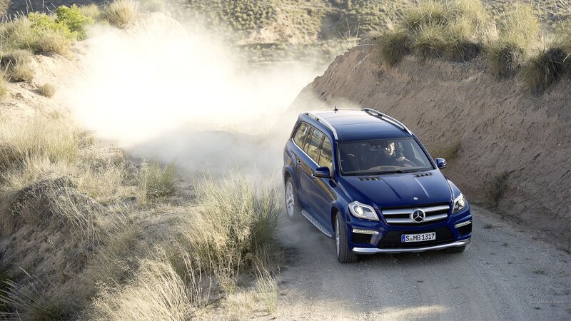 Blue Mercedes-Benz SUV on dirt road
