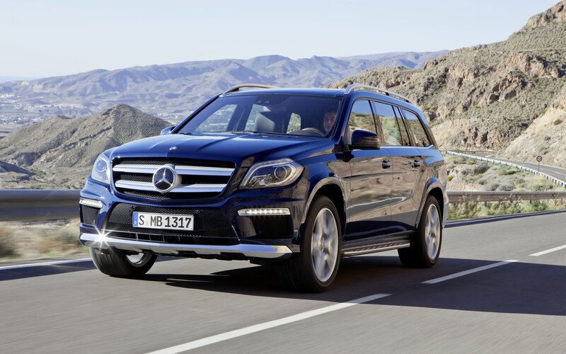 Blue Mercedes-Benz SUV on mountain road