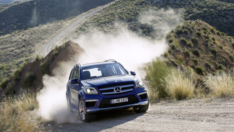 blue mercedes suv on dirt road
