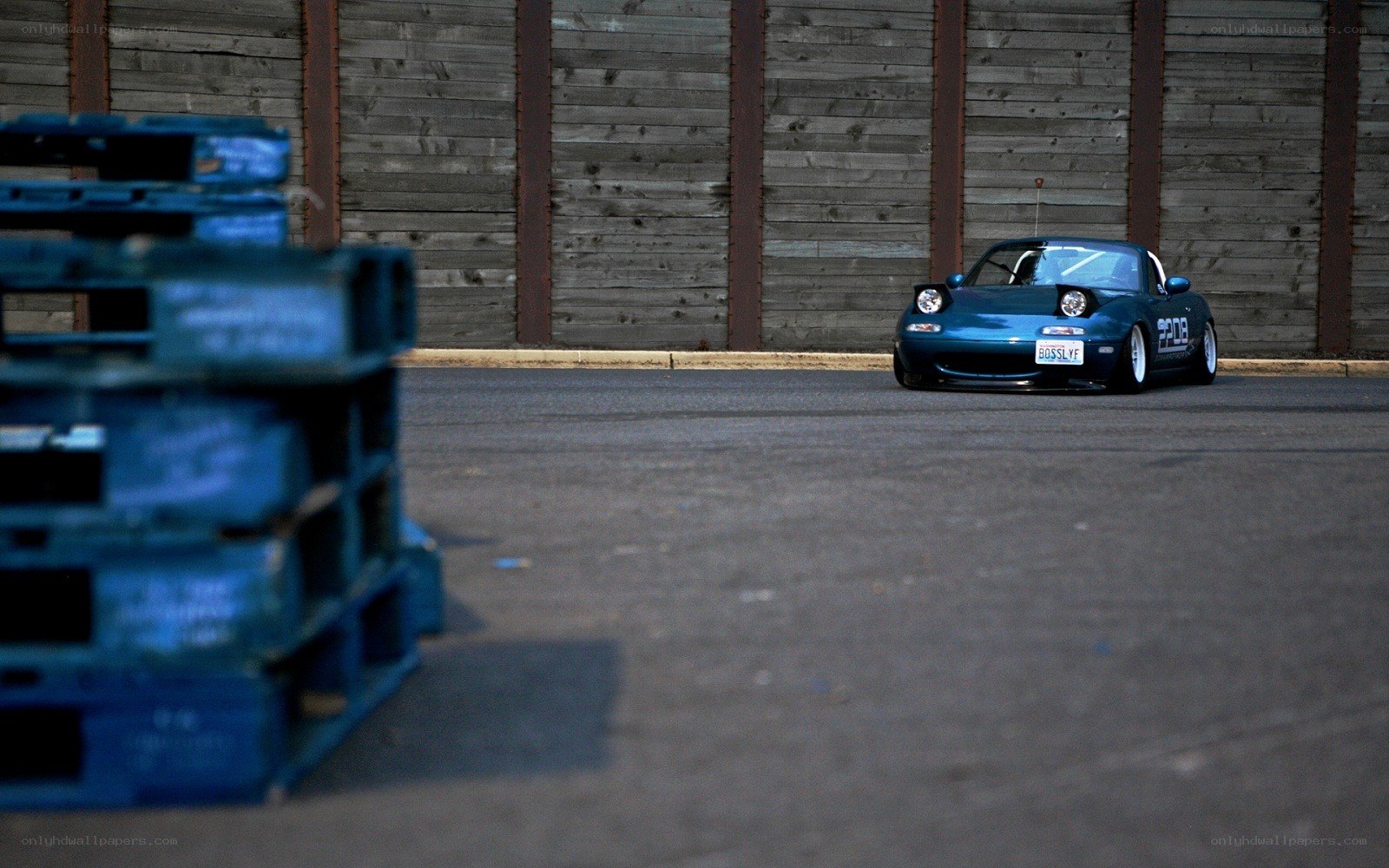 Blue Miata on asphalt
