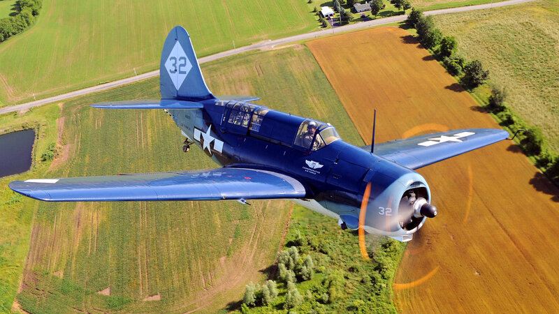 Blue military aircraft in flight