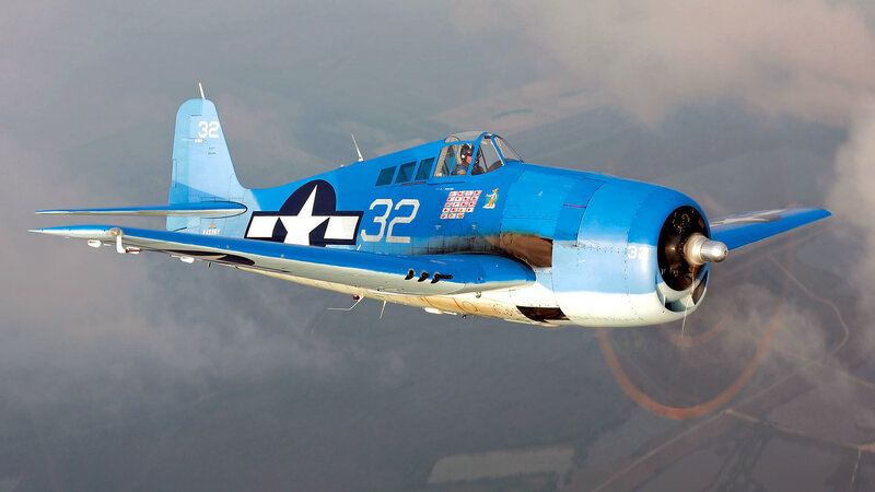 Blue military aircraft in flight