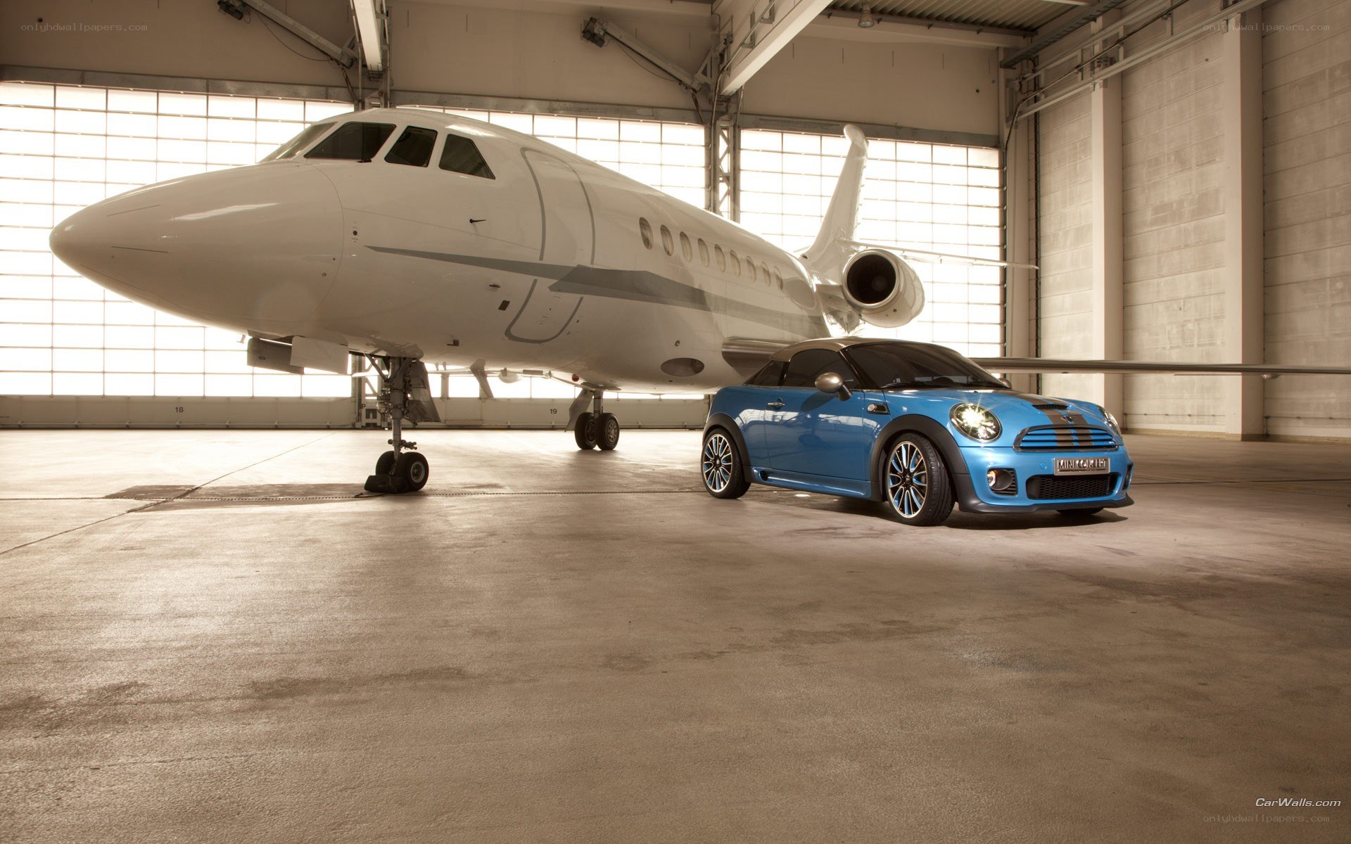 Blue MINI Cooper and private jet