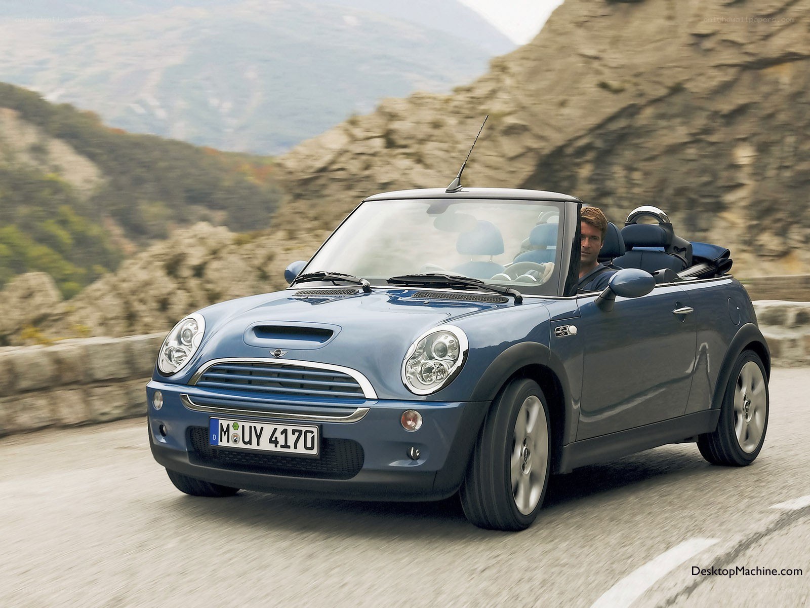 Blue MINI Cooper convertible driving