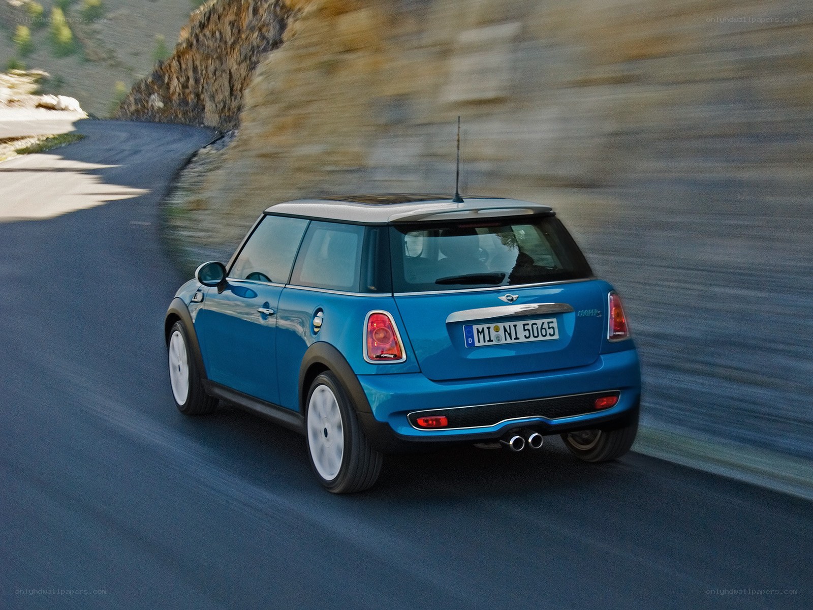 blue mini cooper driving on road