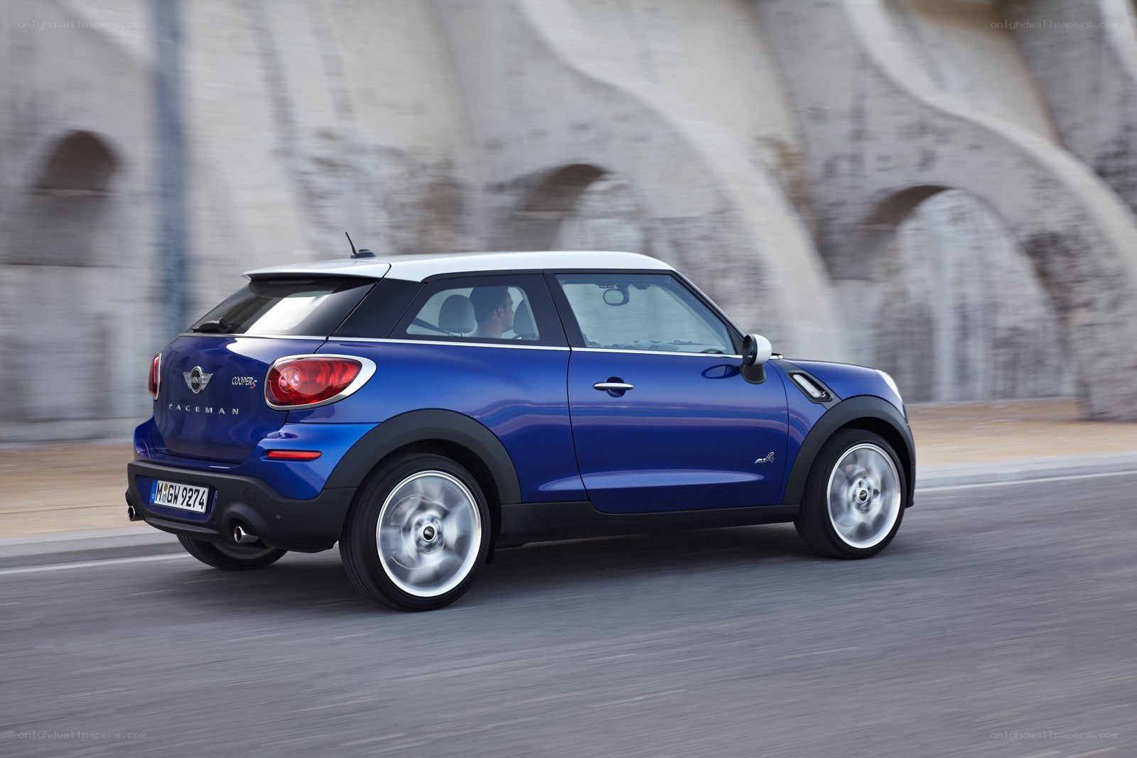 blue mini cooper driving on road