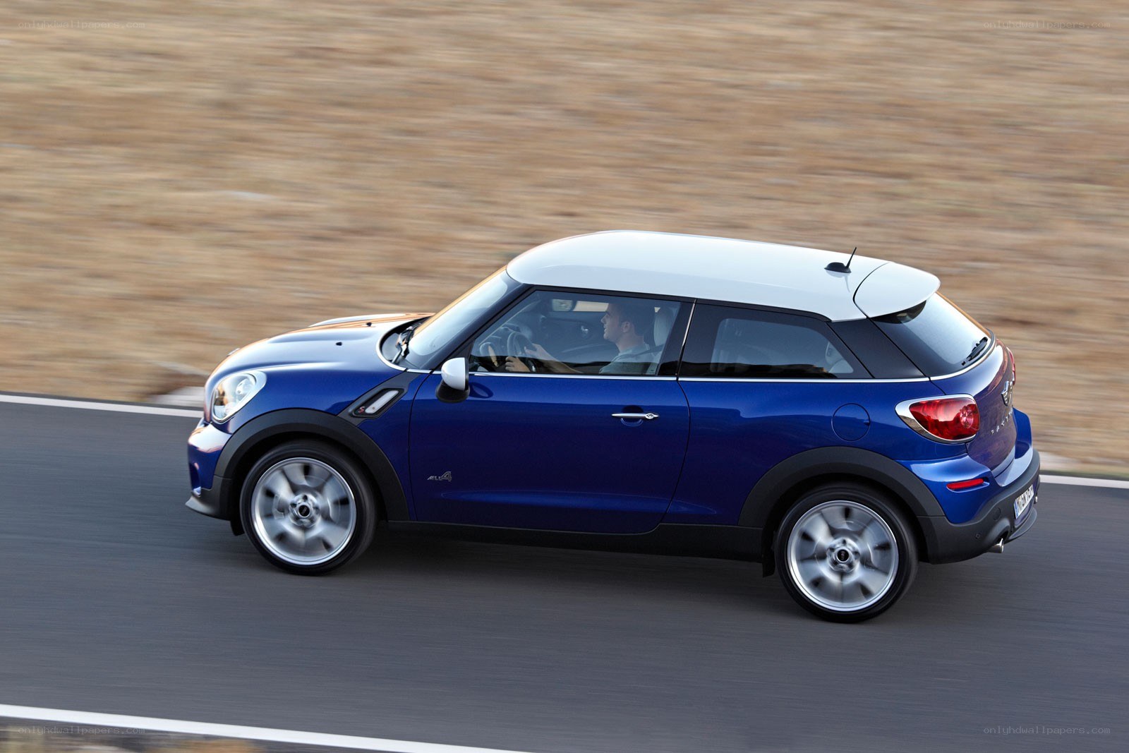 blue mini cooper driving on road