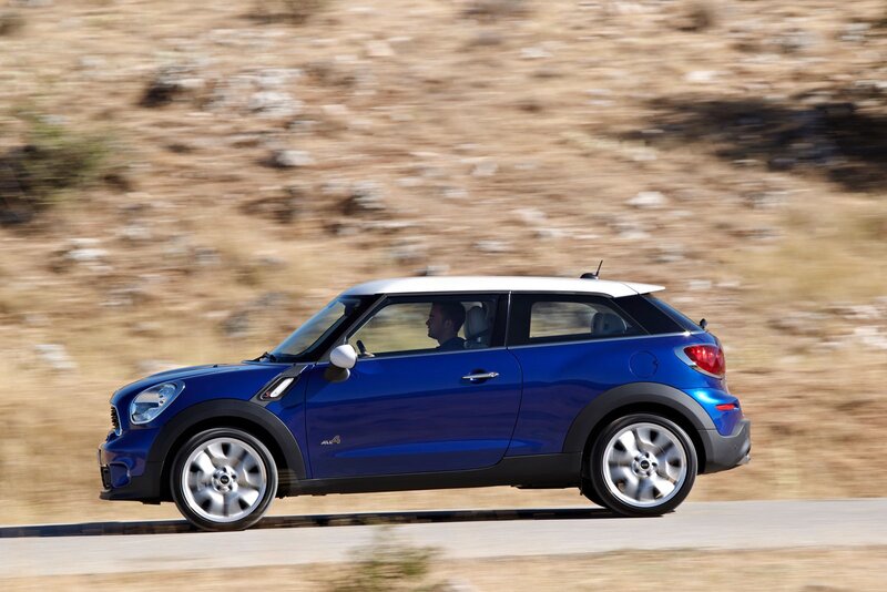 blue mini cooper driving on road