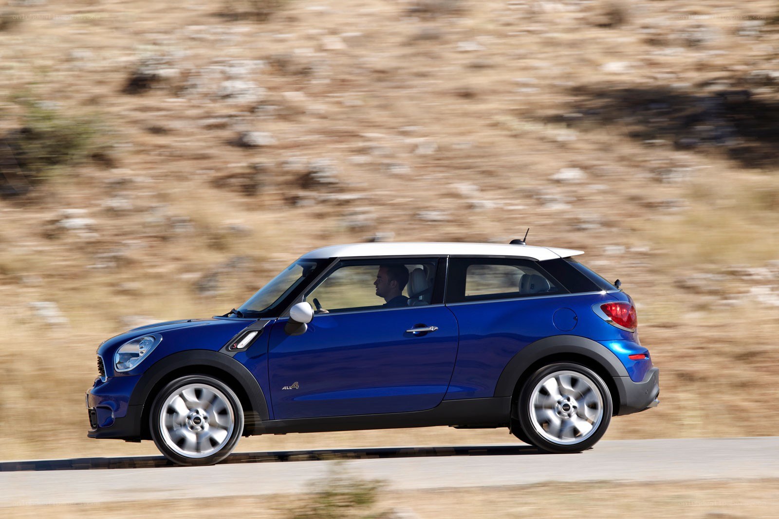 blue mini cooper driving on road