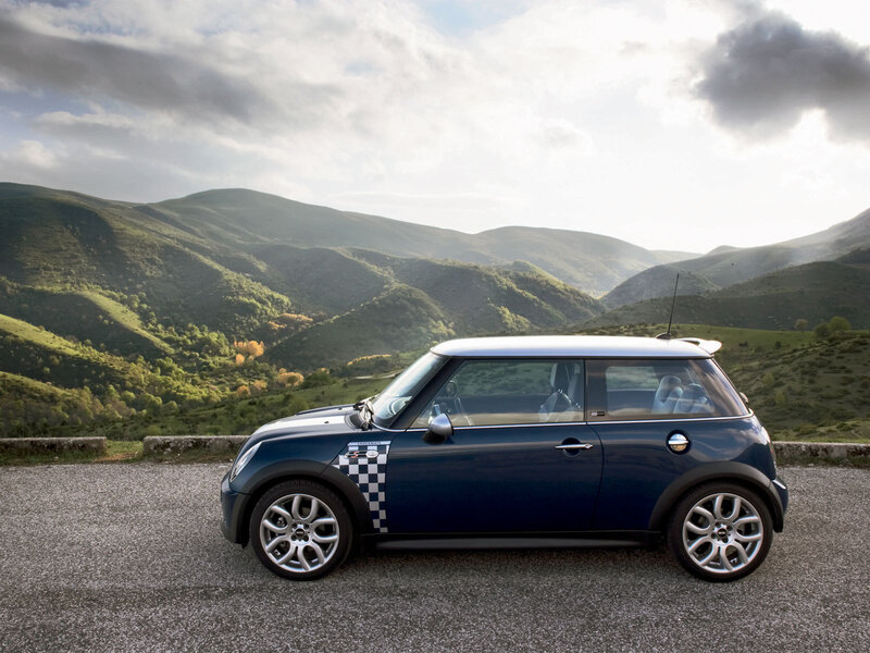 Blue Mini Cooper in mountain landscape