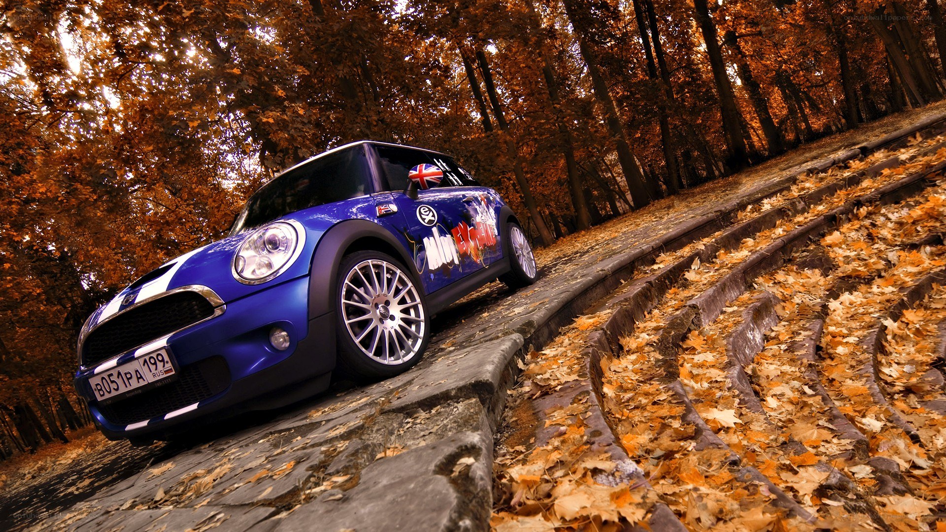Blue Mini Cooper on autumn road