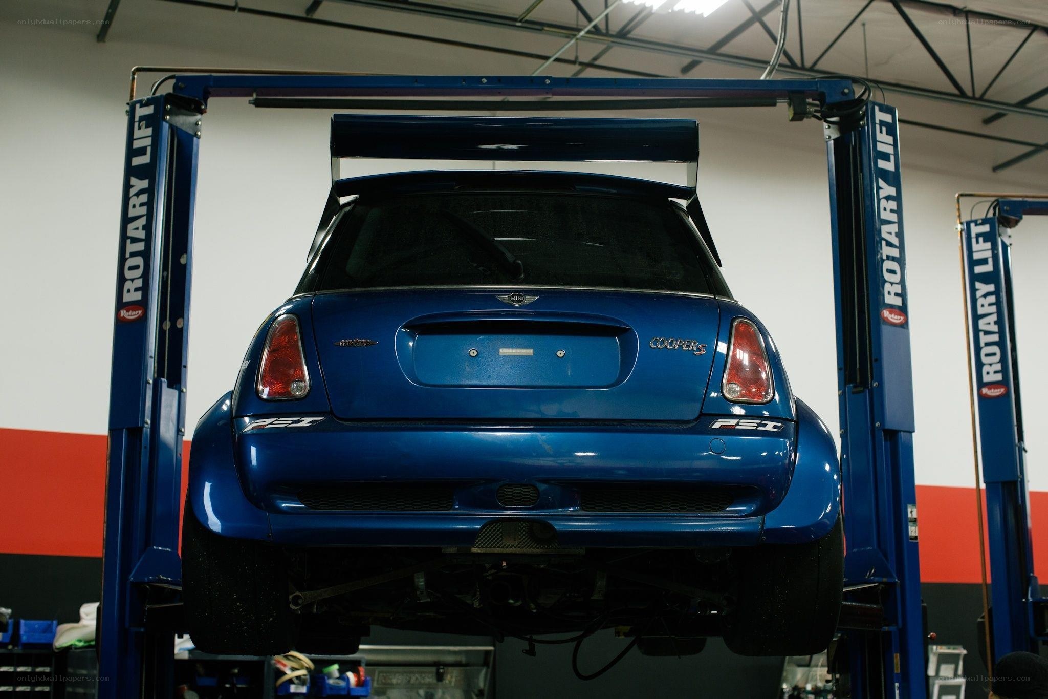 Blue Mini Cooper on lift