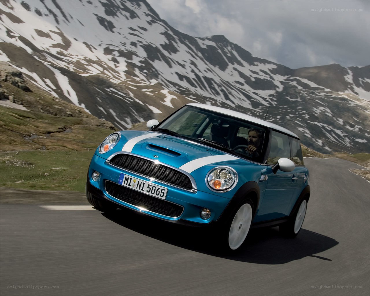 Blue Mini Cooper on mountain road