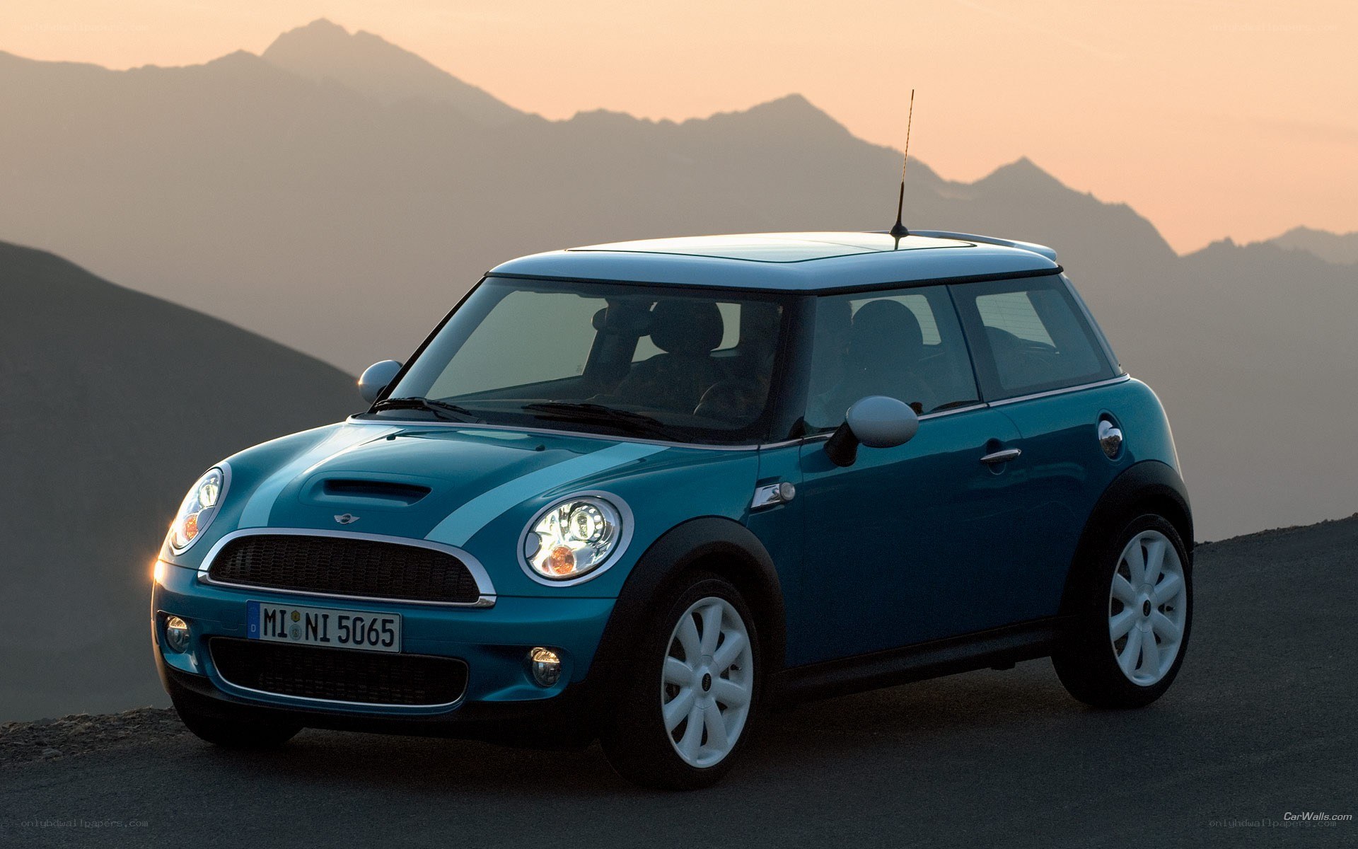 Blue Mini Cooper on mountain road