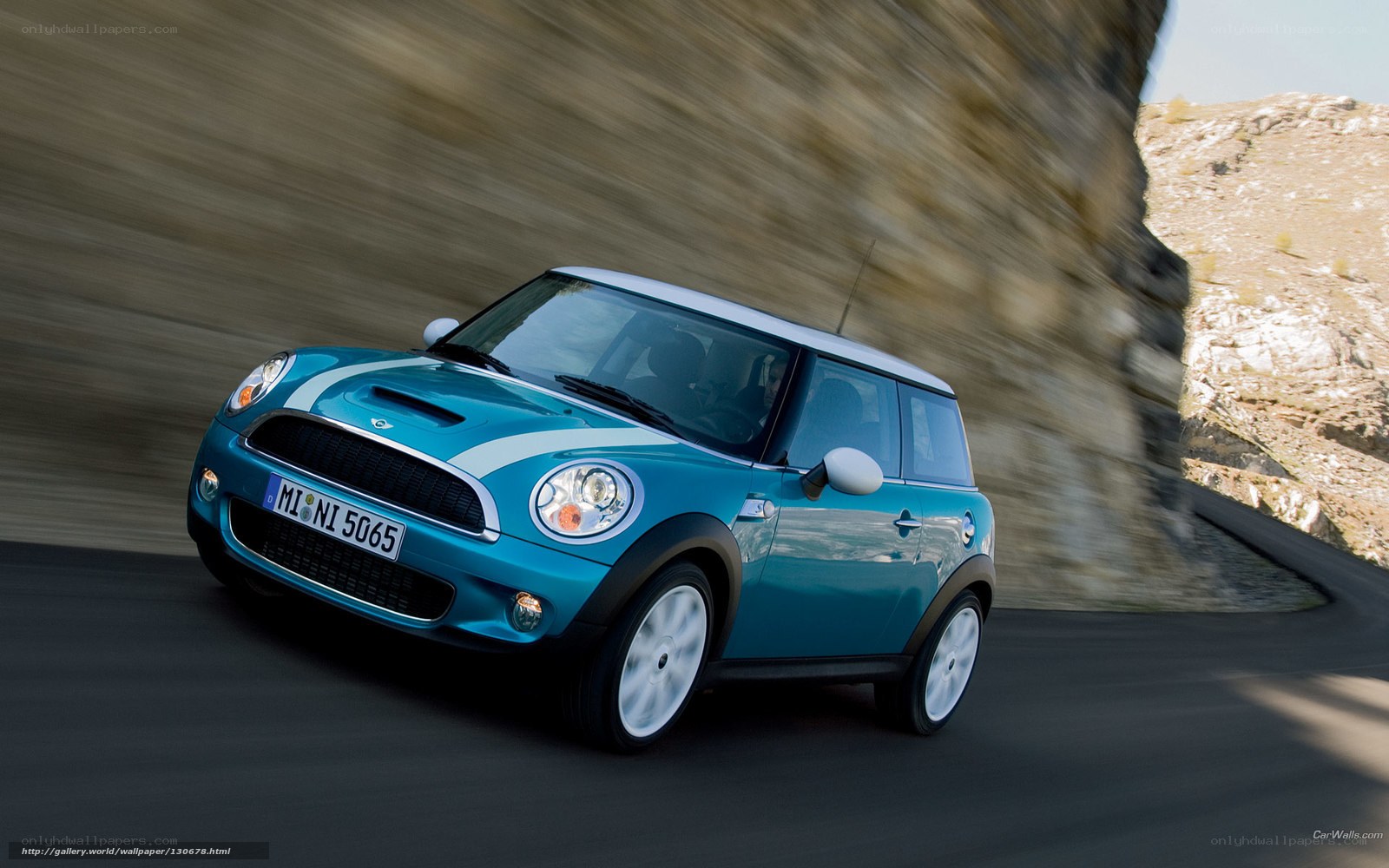 blue mini cooper on winding road