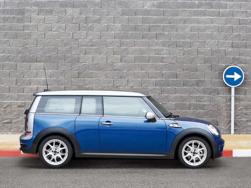 blue mini cooper parked by wall