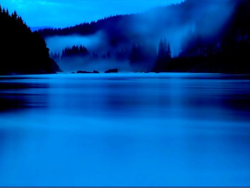 Blue misty lake at dawn