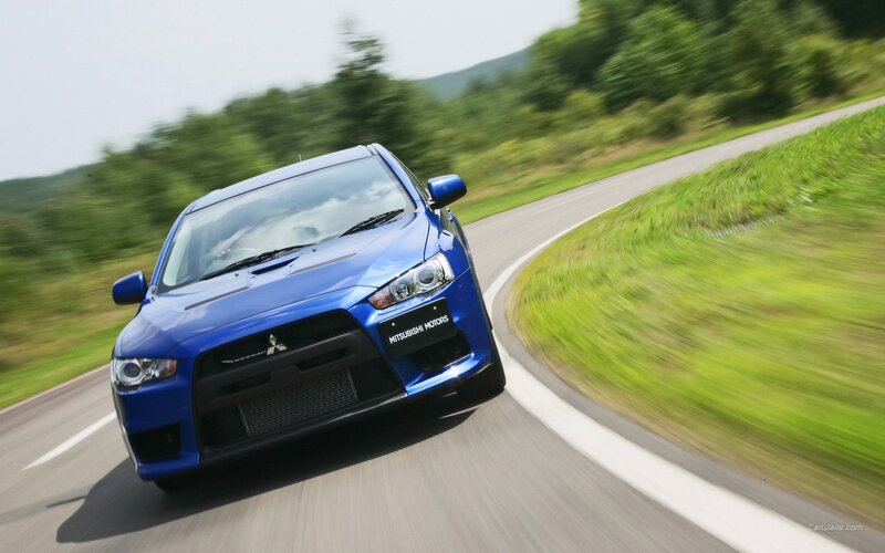 blue mitsubishi car on road